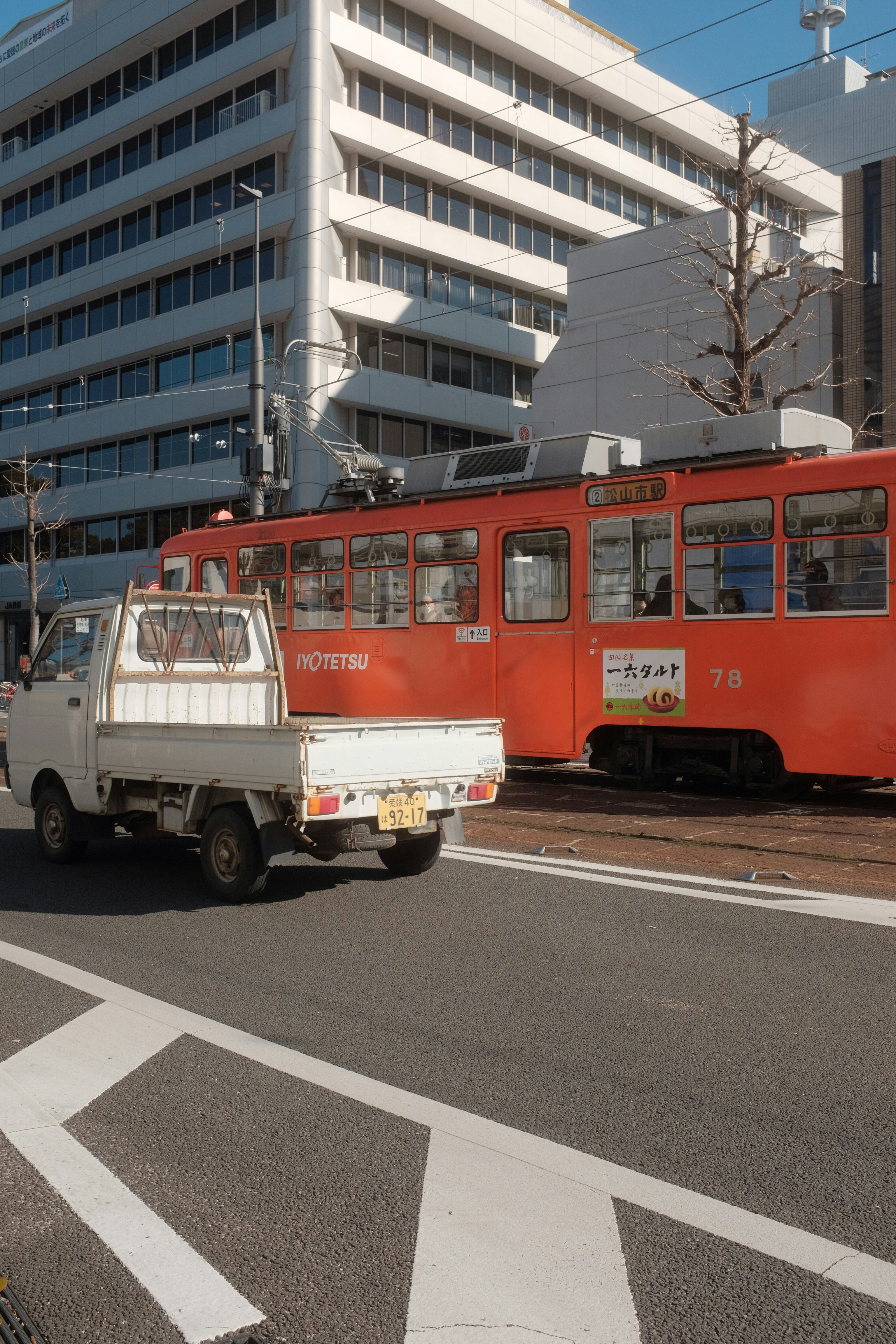 red and white bus on road during daytime